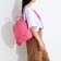 A backpack with a zipper, 5 outer pockets, pink color