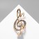 Brooch "Violin key" with pearl notes, the color is white in gold