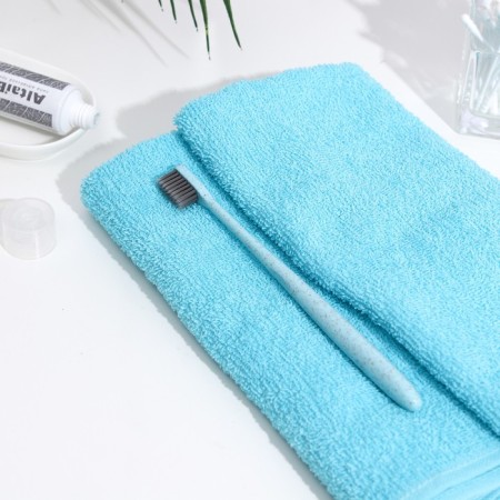 The toothbrush is soft, in the tube, turquoise-1