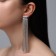 Hanging earrings with Hollywood rhinestones, 8 rows, white color in silver, 12 cm