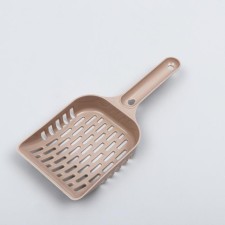 A scoop for cleaning a cat toilet, beige