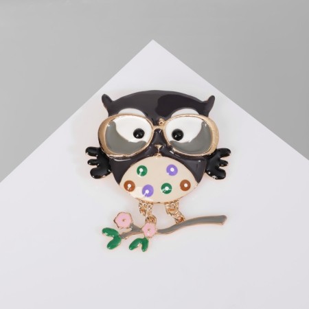 Cartoon “owl” brooch on a branch, colored in gold