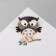 Cartoon “owl” brooch on a branch, colored in gold