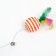 A teaser-pitch with a wicker ball and colored feathers on a wooden handle, orange
