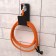 Holder for a garden hose, wall -mounted, with protection against fracture, black