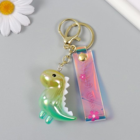 A plastic keychain with a carbine, a dinosaurus strap is green 2.5x5x5x5 cm-3