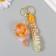 A plastic keychain with a carbine, a strap "Orange" water "water with decor1.8x5.3x5.6 cm