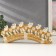 Polystone souvenir "Seven white elephants in golden blankets on a carved tusk" 11x3.5x28.5 cm