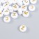 Beads for creativity plastic "White circles with gold letters" set 10 grams 0.6x1x1 cm