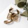Brooch "Scorpio" in armor, black-green color in black gold