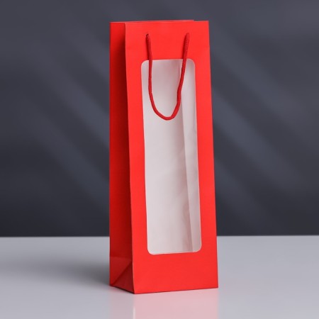 A package for a bottle with a plastic window 12.5 × 8.5 × 36 cm, red