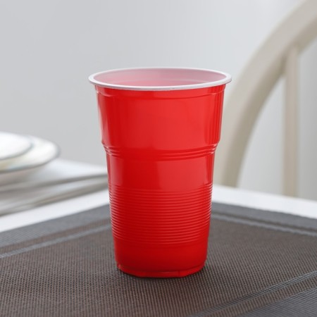 A glass of plastic disposable “torch Extra”, 500 ml, red-white color