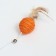 Testing "Sisalem Ball" with feathers and a bell, on a wooden handle, 40 cm, orange ball