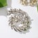 Shining spiral brooch, white color in silver