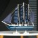 The ship souvenir medium "Kalev", the sides are blue with a white strip, the sails are blue, 30x7x32 cm