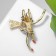 Brooch "Cat" on a broomstick, color in gold