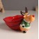 Ceramics stand "Elk in a green fur coat with a large red bag" 12.5x19.1x13.1 cm