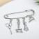 Swabe pin, 6.5 cm, white color in black silver