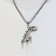 Pompeii pendant dinosaurus, black color in silver, 70 cm