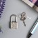 A hinged metal lock for caskets with a key of 3.3x1.9 cm