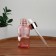 A glass bottle for storage, with a pipette, 30 ml, pink/pink gold color