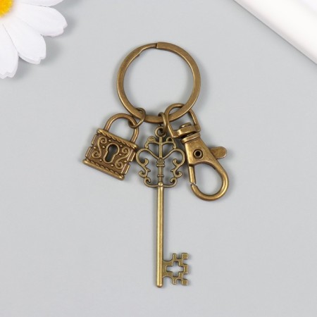 A metal keychain with a carbine "openwork key and a lock" bronze 8.6 cm