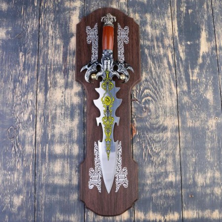 A souvenir sword on a tablet, a carved blade with a pattern, the claws of the eagle on the handle, the blade 41 cm