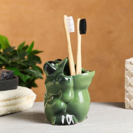 A glass under the toothbrush "Frog"