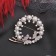 Brooch "Butterflies in a pearl wreath", the color is white in pink gold