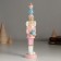 Polystone souvenir "Nutcracker in a pink uniform, with a gift" 4.5x4.5x21 cm