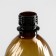 A disposable plastic bottle, 1 l, PET, without a lid, brown color